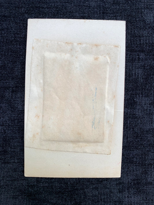 Rectangular white stone object on a dark fabric background