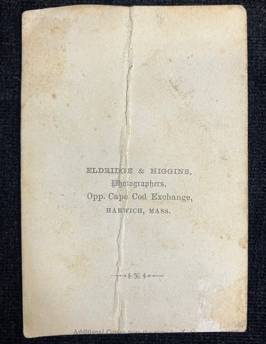 Vintage photograph album page with text 'Eldridge & Higgins, Photographers, Opp. Cape Cod Exchange, Harwich, Mass.'
