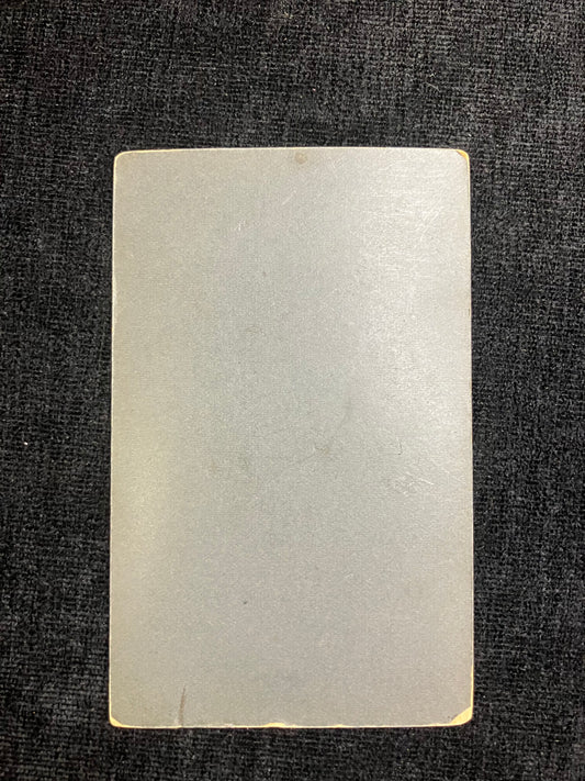 Rectangular white card on a textured black background
