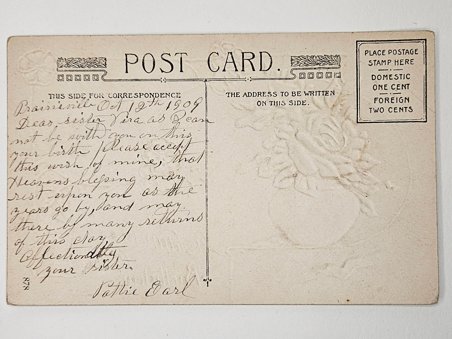 Vintage postcard with handwritten text and postage stamp area on a white background