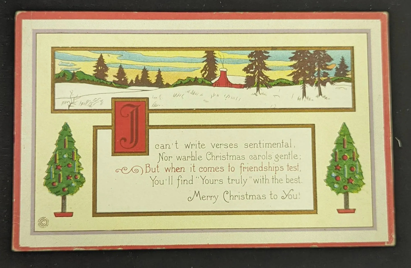 Vintage Christmas card with trees, a cabin, and text on a black background