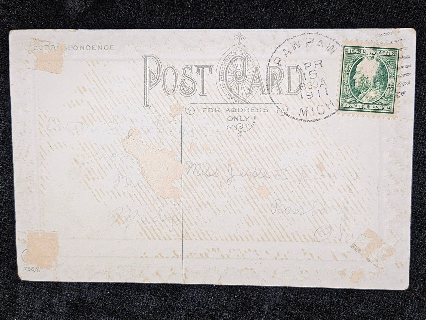 Vintage postcard with a stamp and text on a dark background