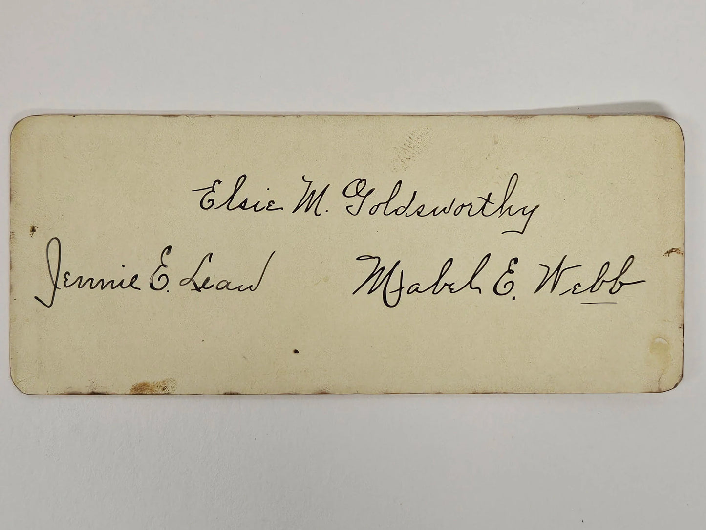 Vintage card with handwritten names on a white background