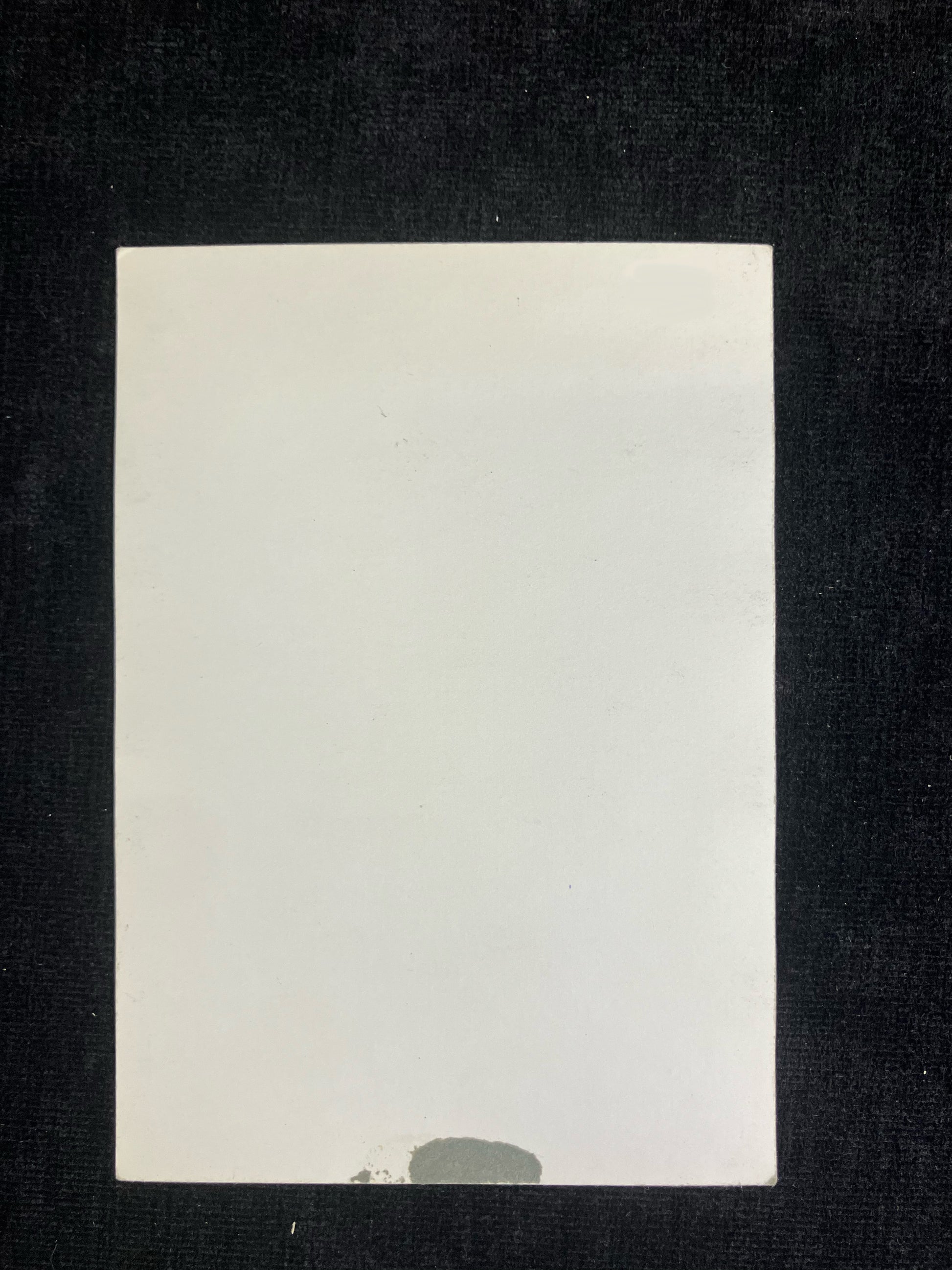 White card with a black border on a dark background