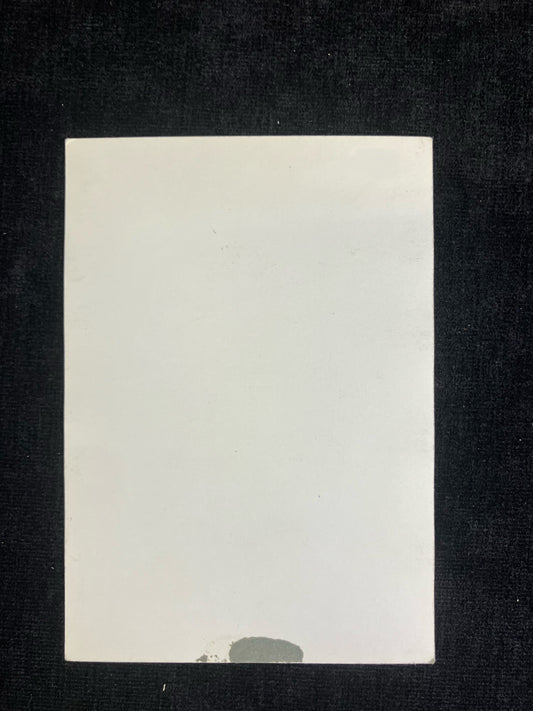 White card with a black border on a dark background