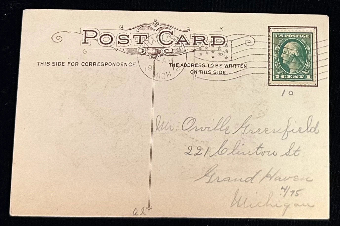 Vintage postcard with a stamp and handwritten address on a black background