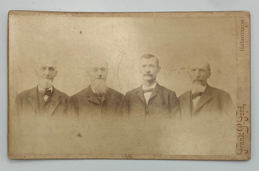 An antique sepia-toned cabinet card photograph showing four men in formal suits, with handwritten text along the right edge including 'Kalamazoo' and 'Frank P. Ford'.
