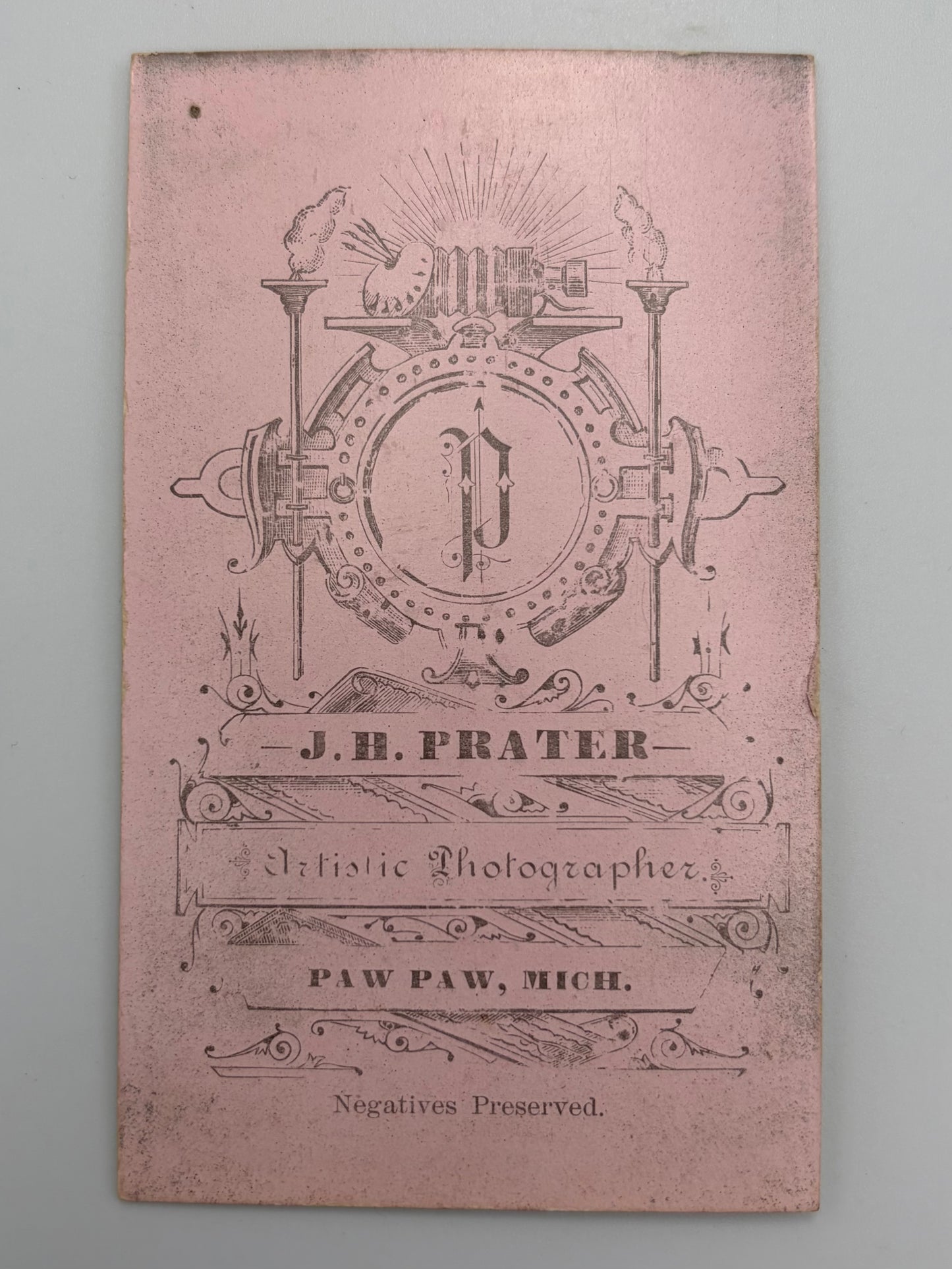 A vintage pink card for J.H. Prater in Paw Paw, Michigan