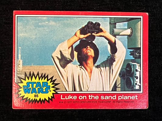 Vintage Star Wars trading card featuring Luke Skywalker on sand planet Tatooine with a red border.