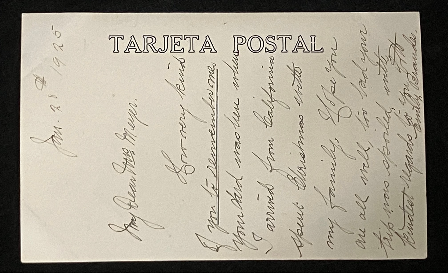 A vintage handwritten postcard with 'TARJETA POSTAL' printed vertically on the left side, photographed against a dark background.