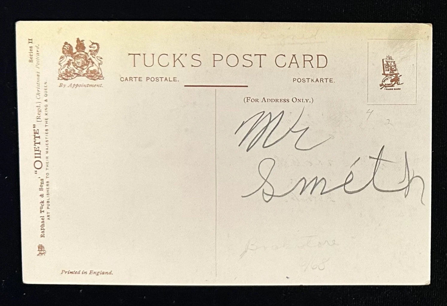 Back of a Tuck's postcard with a signature and logo