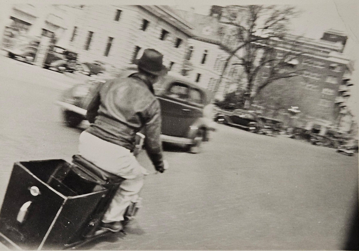 1940s Black and White Motion Photography - Man Traveling On Scooter/Motorcycle down city street