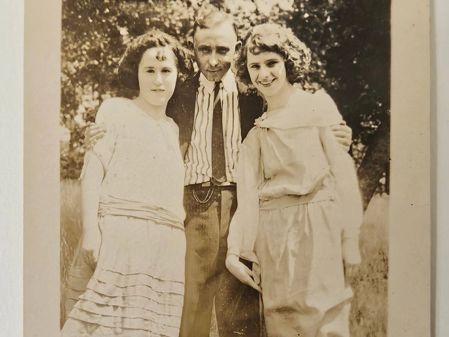 1915 Photo of 3 Well Dressed Siblings Smiling - Older Brother with younger Sisters Casual Photo outdoors - Sepia Tone Photograph