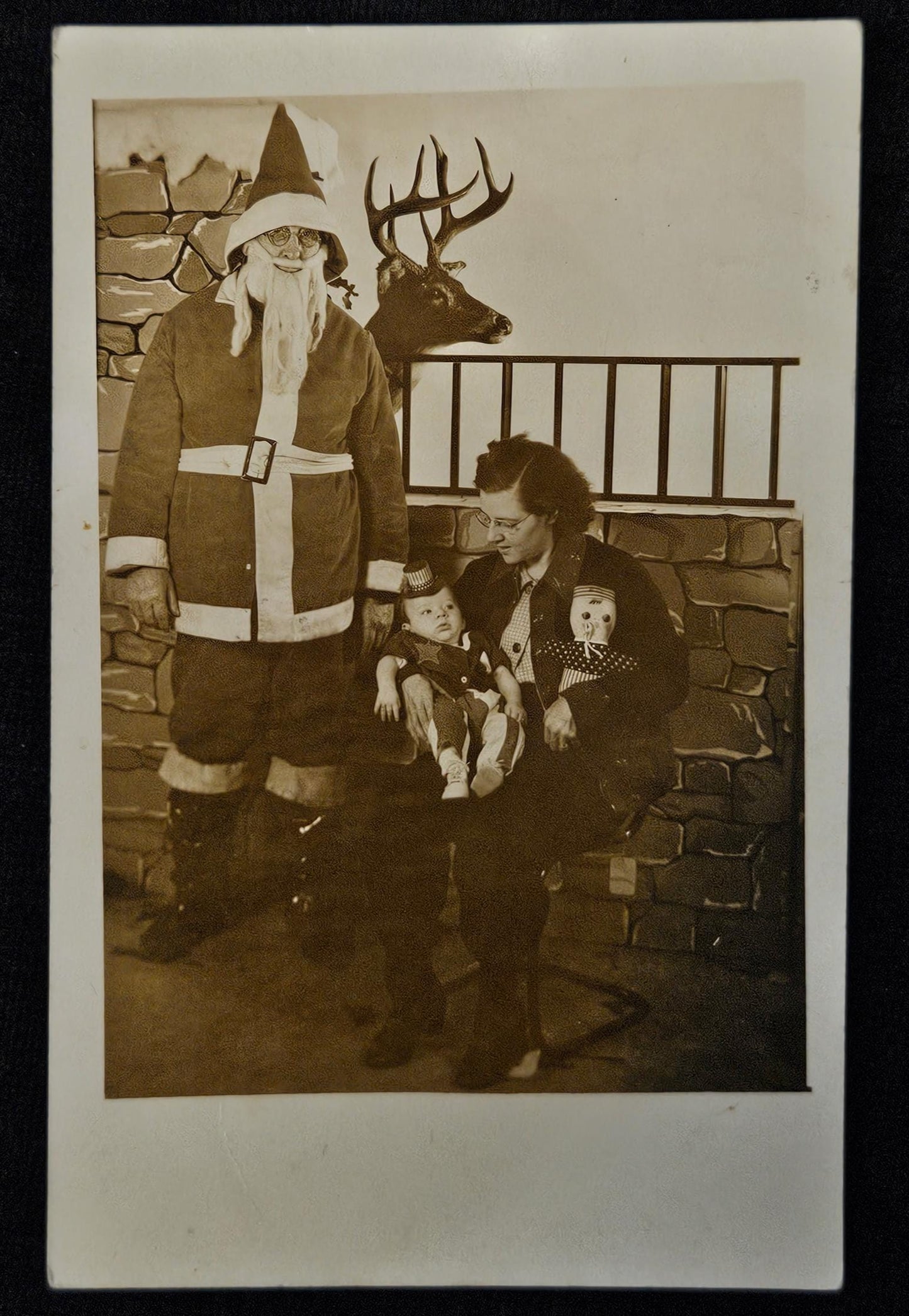 RPPC - Santa Claus with Mother and Baby - Taxidermy Deer in Background - Sepia Toned Christmas Photo Postcard from 1930s - Fun Photo Backdrop