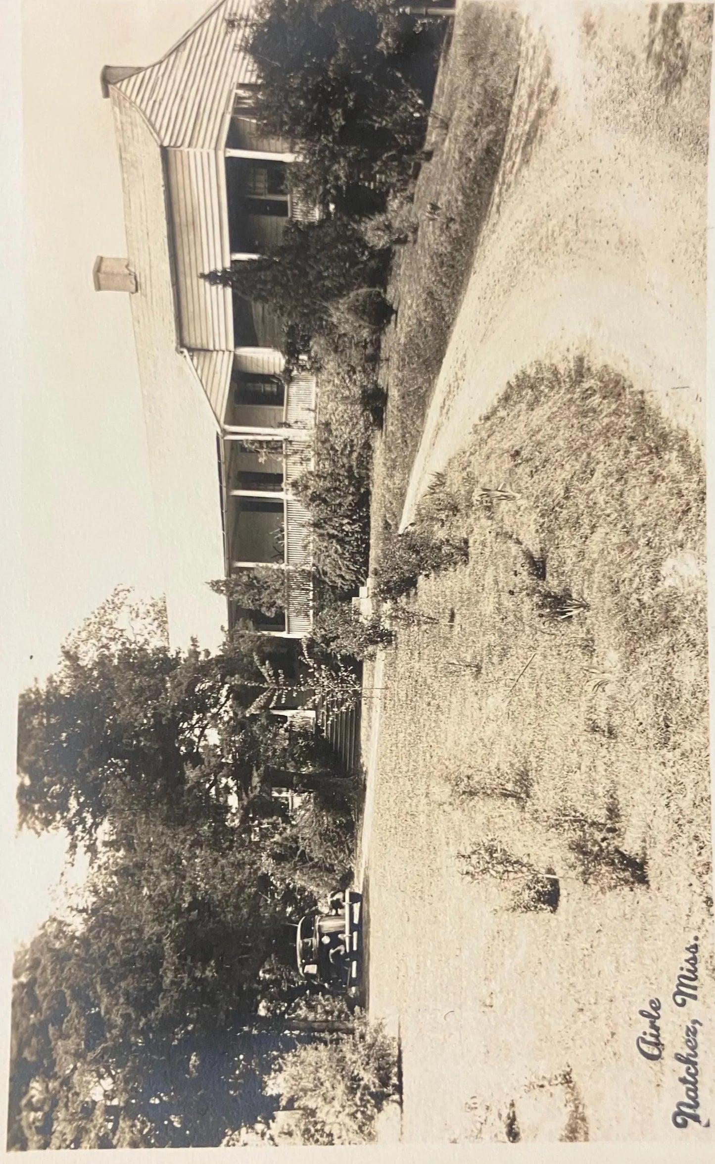 Vintage black and white photo of a house with a garden
