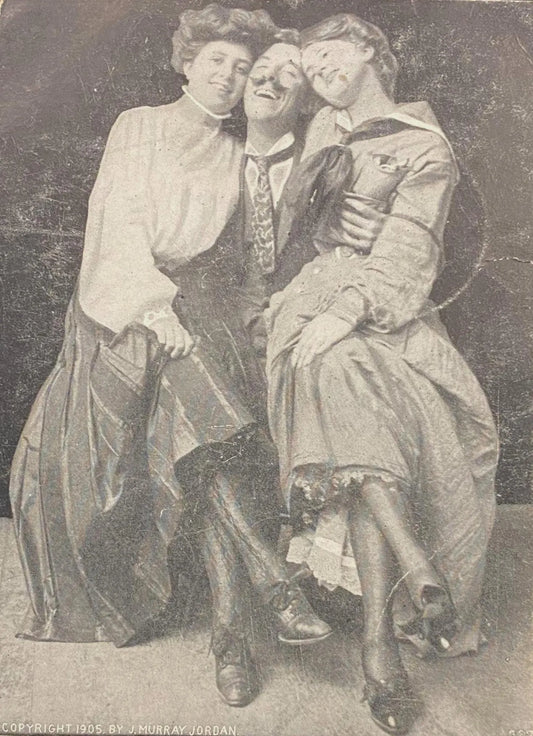 Three people posing together in a vintage romance photograph