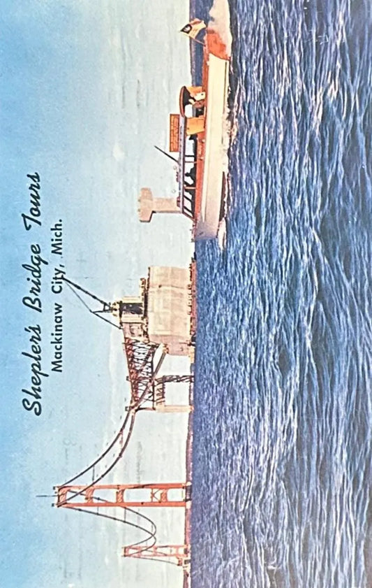 Vintage postcard of construction of the Mackinaw Bridge with Sheplers Bridge Tours text.