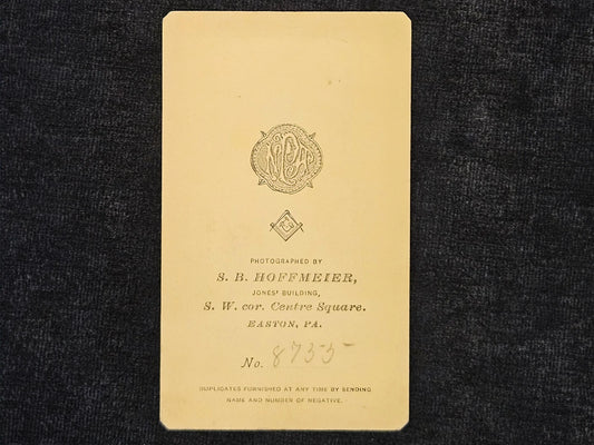 Vintage photograph album page with a logo and text on a dark background