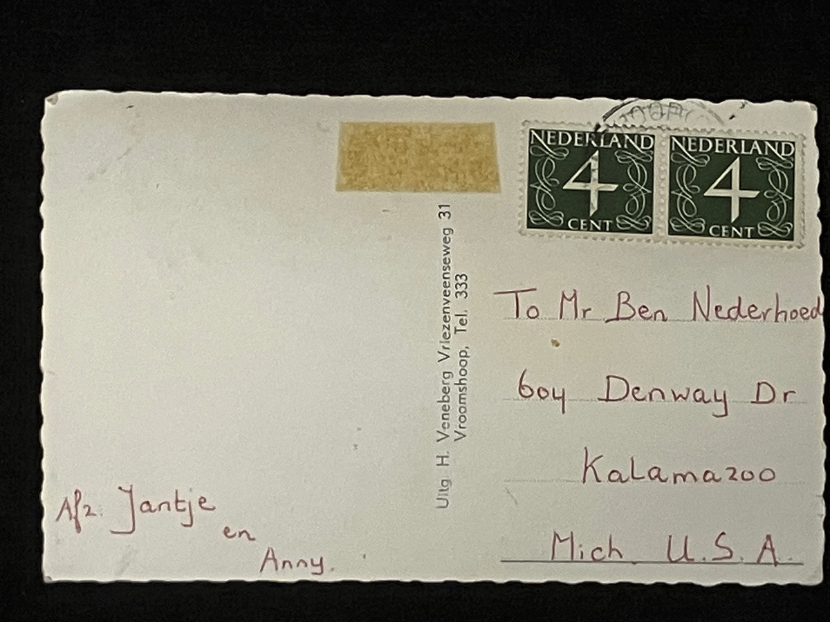 Vintage Dutch postcard with postage stamp and handwritten text. Two4 cent stamps, handwriting, postmark present but obscured
