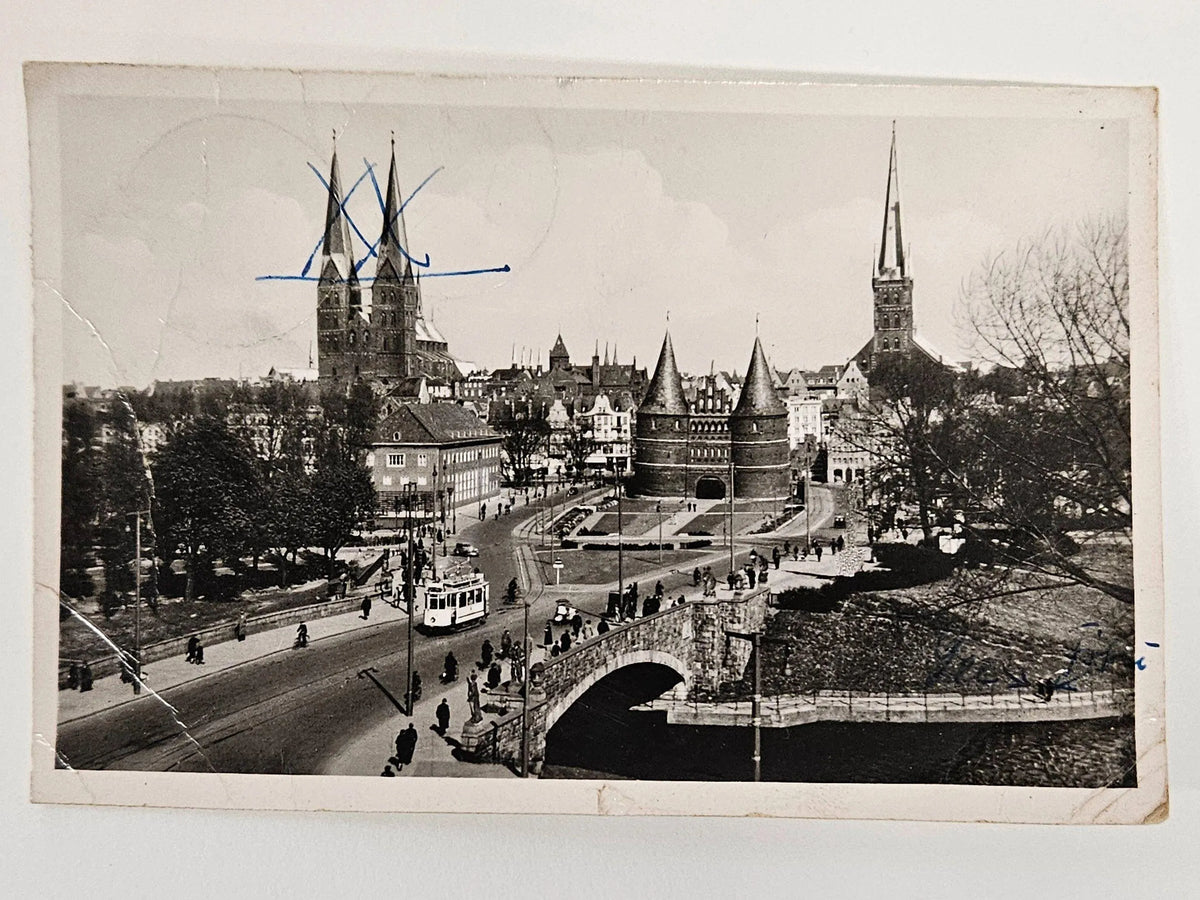 Vintage black and white photograph of a cityscape with a bridge and tall buildings.