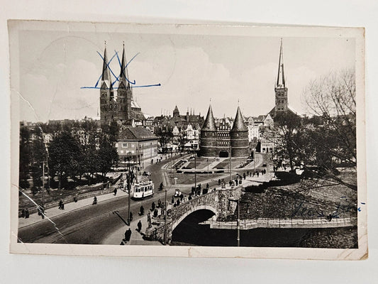 Vintage black and white photograph of a cityscape with a bridge and tall buildings.