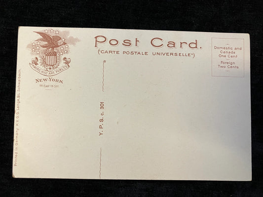 Back of a vintage postcard with New York address and postage stamp design.