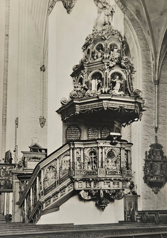 Decorative pulpit in a church with intricate carvings and statues.