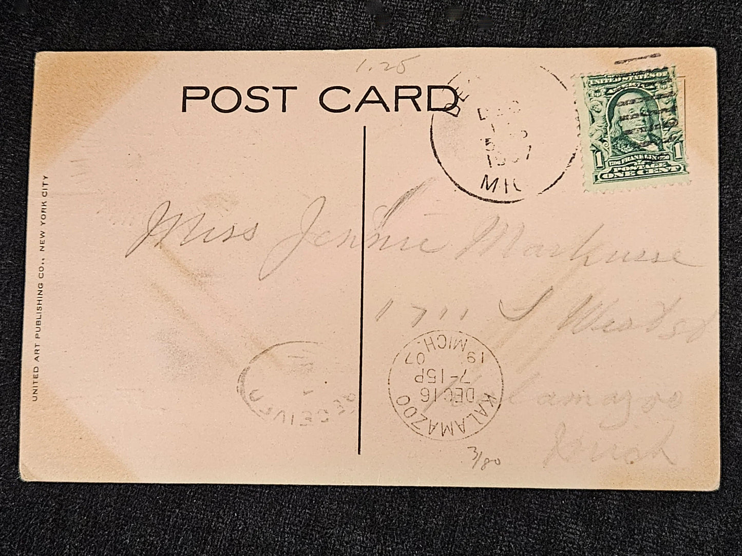 Vintage postcard with postage stamp and stamps on a black background