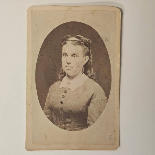 Vintage oval portrait of a woman with a plain background
