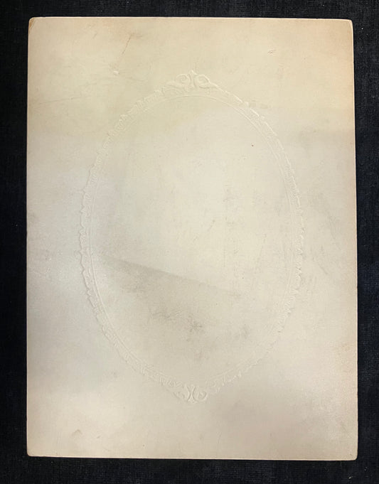 Beige textured paper with circular patterns on a black background