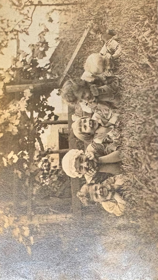 Vintage black and white photo of a group of people outdoors with a rustic background