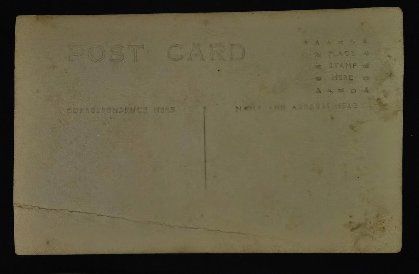 Vintage postcard with text and a tear on the back