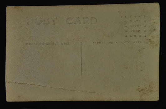 Vintage postcard with text and a tear on the back