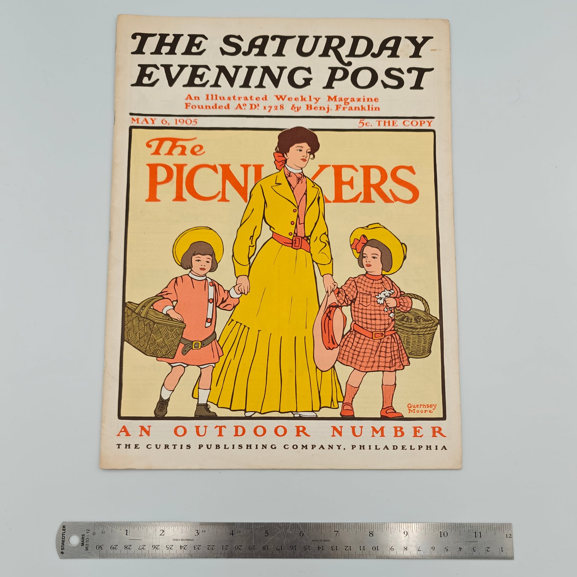Vintage magazine cover of 'The Saturday Evening Post' with a woman and two children, ruler for scale.