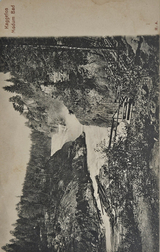 Offset printed black and white photo of a forest landscape with a waterfall, featuring a message on the back with postmarks.