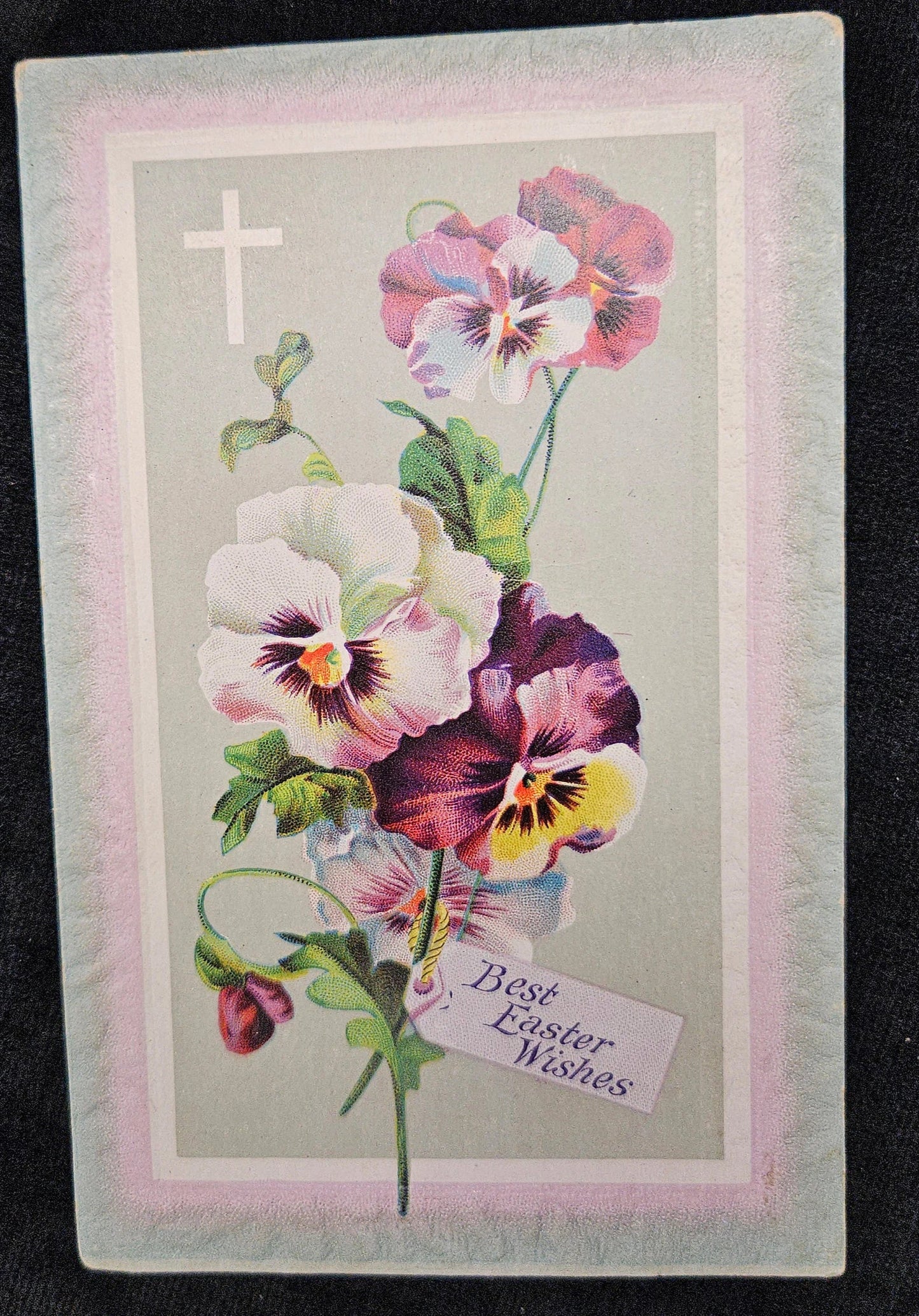 Vintage Easter card with colorful flowers and a cross on a dark background