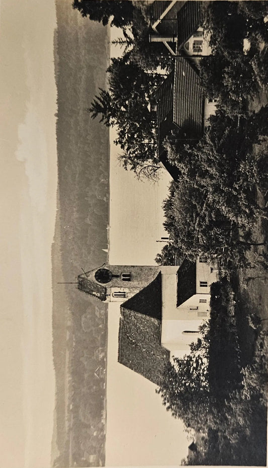Vintage photograph of a church with trees and a clear sky