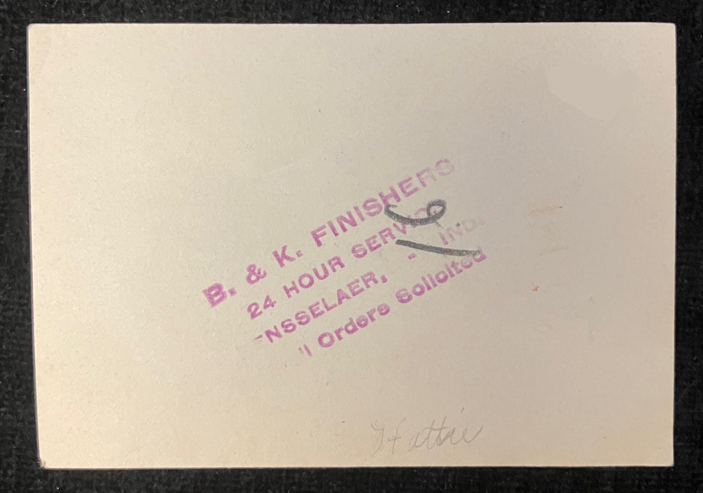 Vintage photograph album page with text and a number '9' on a black background