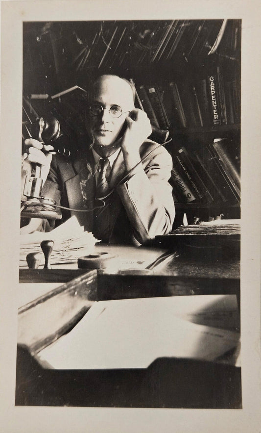 1929 Photo of A Man Named Ray on Phone Call - Man in Black and White Photo with round glasses