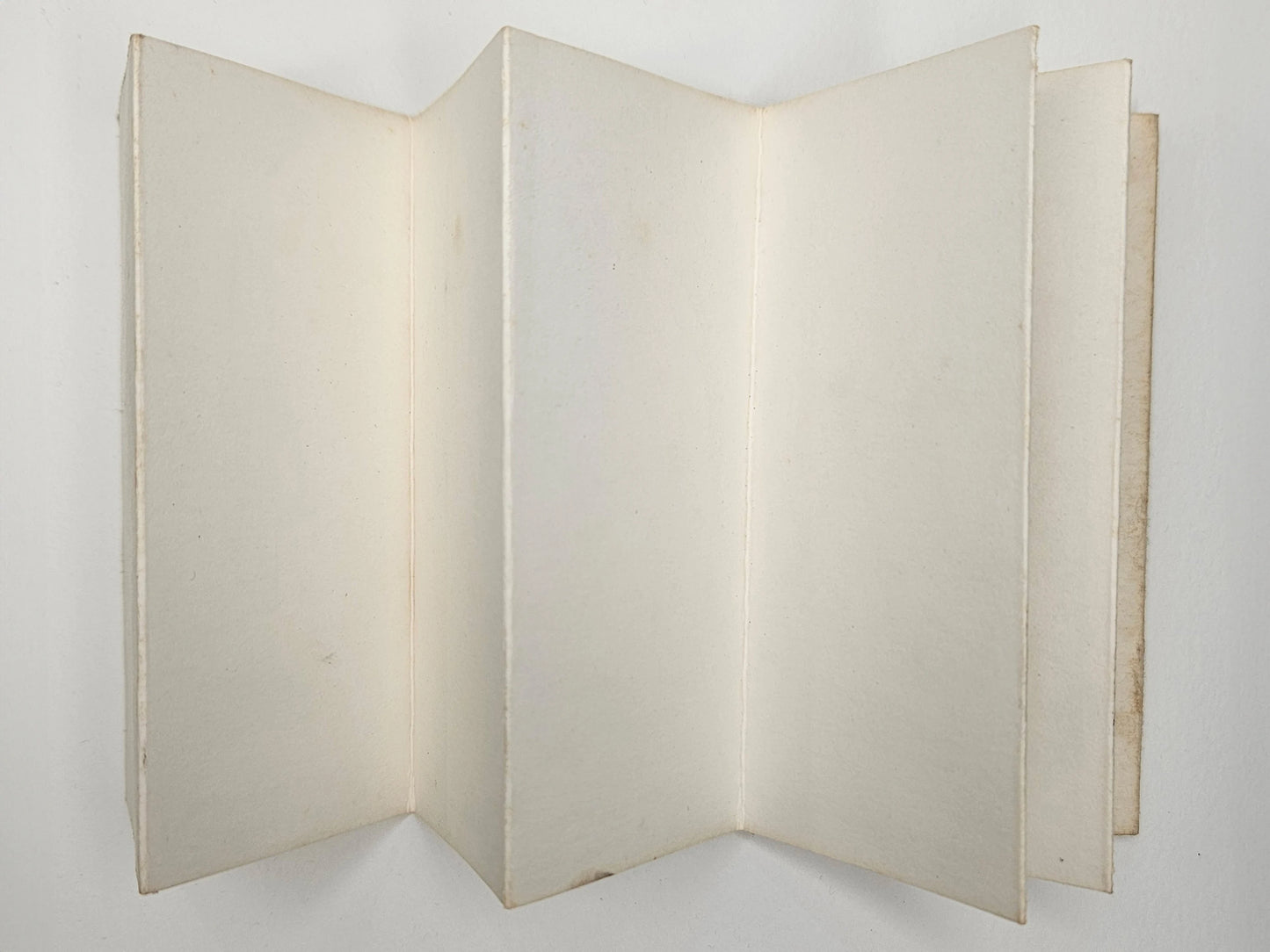 Foldable beige display board on a white background