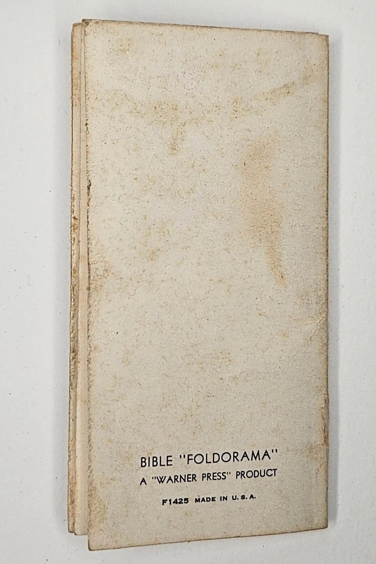 Vintage 'Foldorama' Bible cover with 'Warner Press' branding on a white background