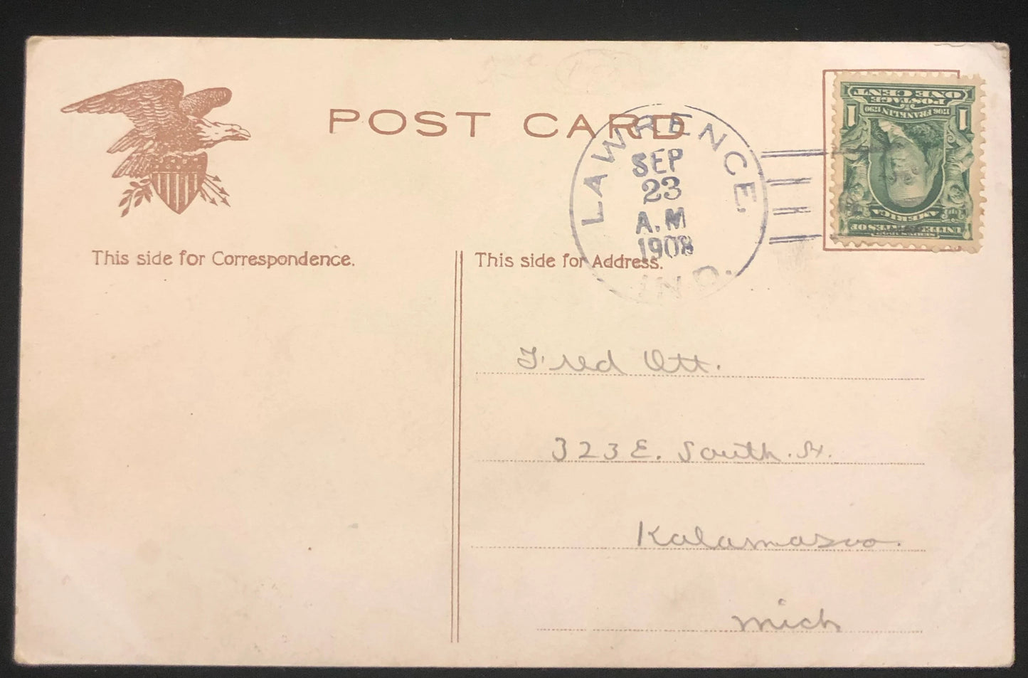 Vintage postcard with an eagle emblem and postage stamp, addressed to a recipient in Michigan.