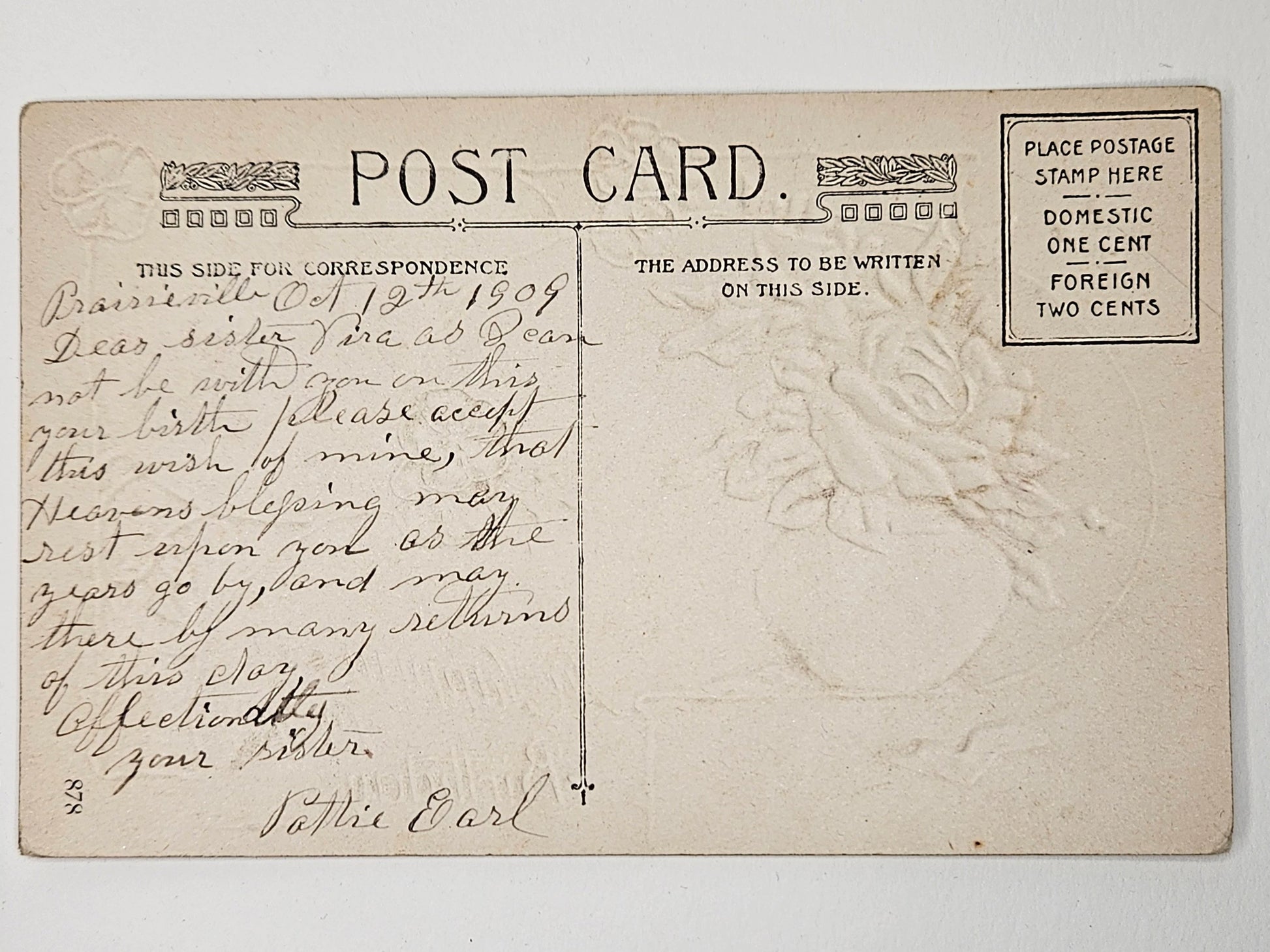 Vintage postcard with handwritten text and postage stamp area on a white background