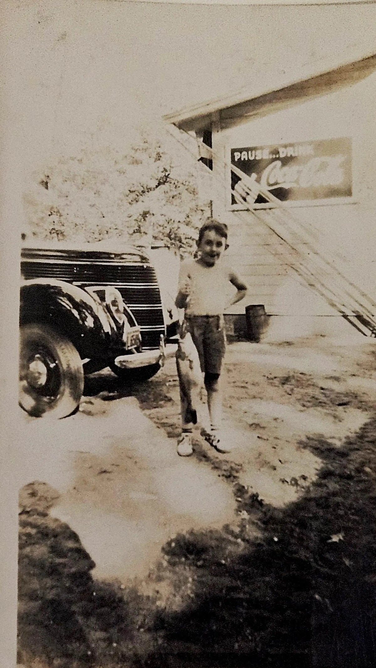 Jack at Big Star Lake Michigan Holding Fish in Front of Coca Cola Ad