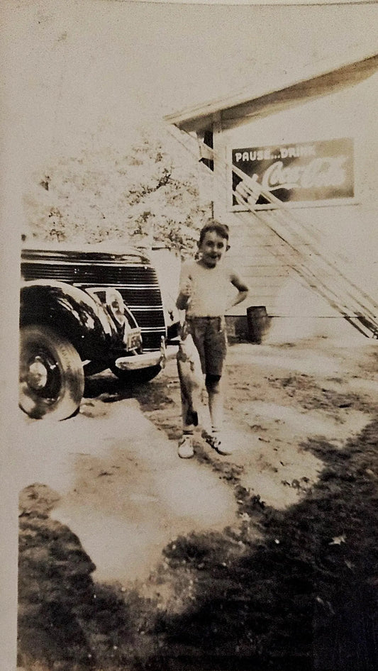 Jack at Big Star Lake Michigan Holding Fish in Front of Coca Cola Ad