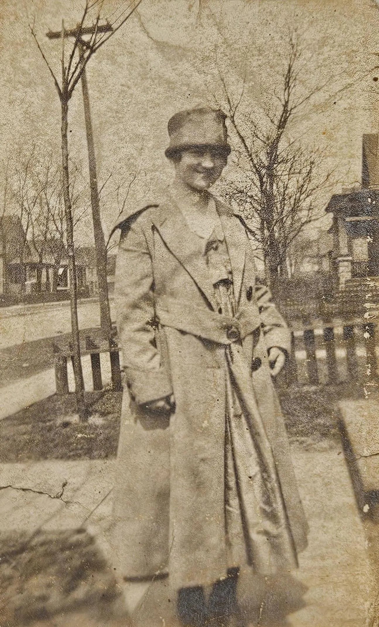 1910s-1920s Photo Of Woman In Trench Coat And Pillbox Hat - Midwest-Northeast Scene In the Front Yard - Smiling 1910s Photography