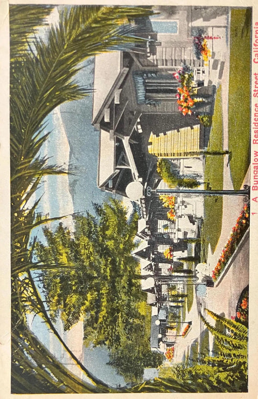 Vintage postcard of a California residential street with houses, trees, and palm leaves.