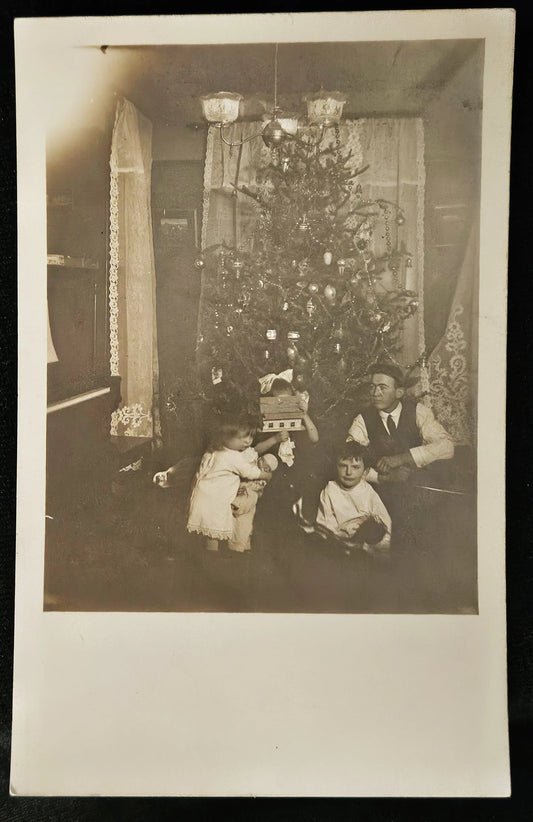 RPPC Christmas Father with 3 Children by Christmas Tree -1915 era Real Photo Christmas Postcard -Funny Action Photo of Family Holiday - RARE