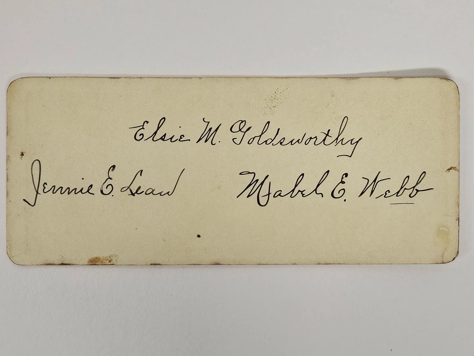 Vintage card with handwritten names on a white background