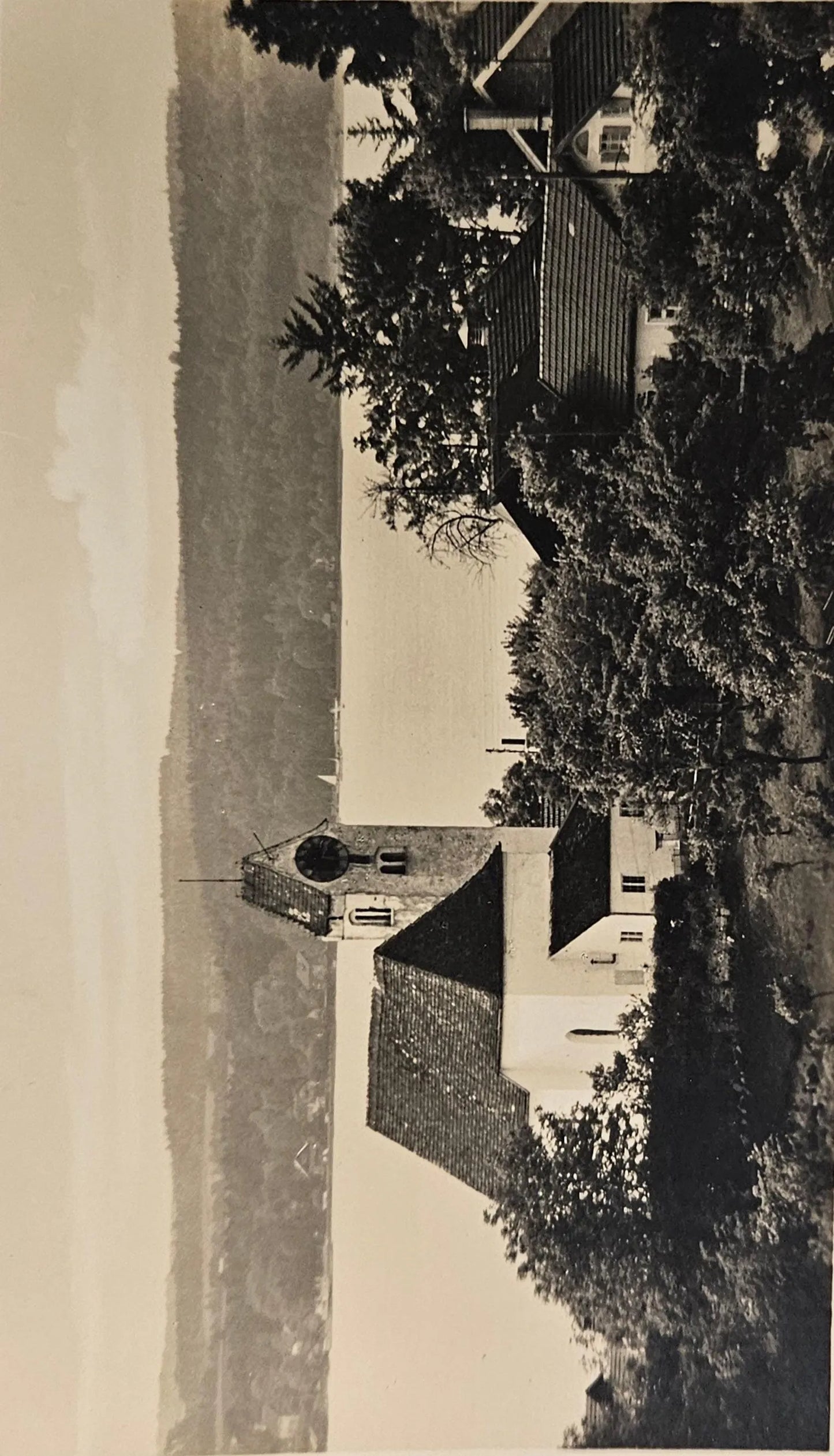 Vintage photograph of a church with trees and a clear sky